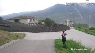 Massive mud flow slams through Swiss town [upl. by Xena]